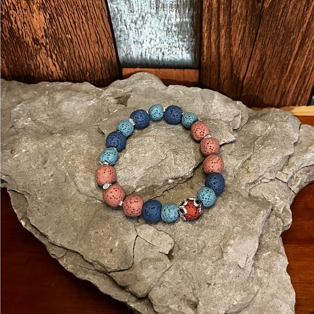 Handcrafted stretch diffuser bracelet with pink and blue lava stones.
